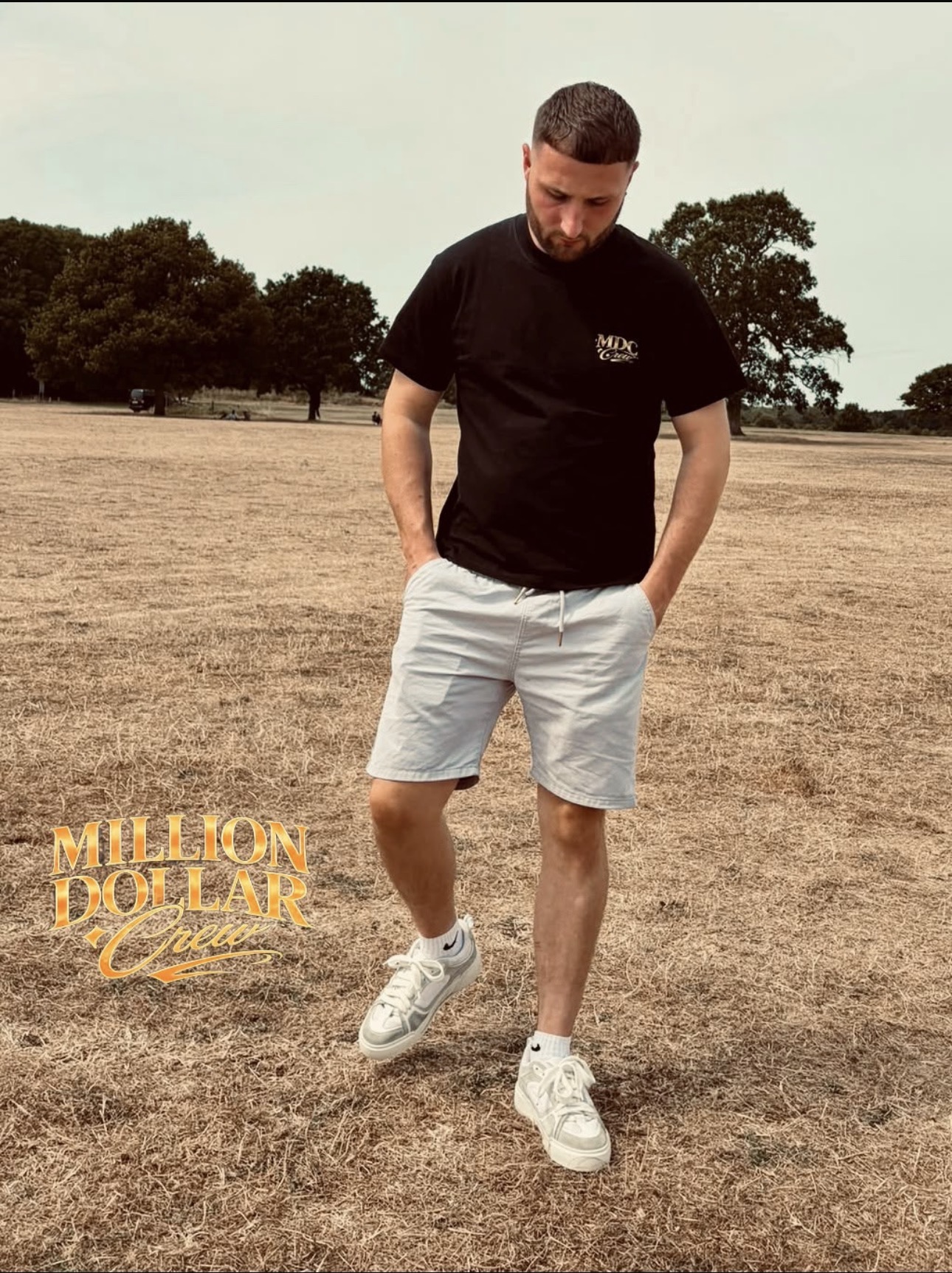 Man wearing the black Million Dollar Crew Drop 01 t-shirt outdoors